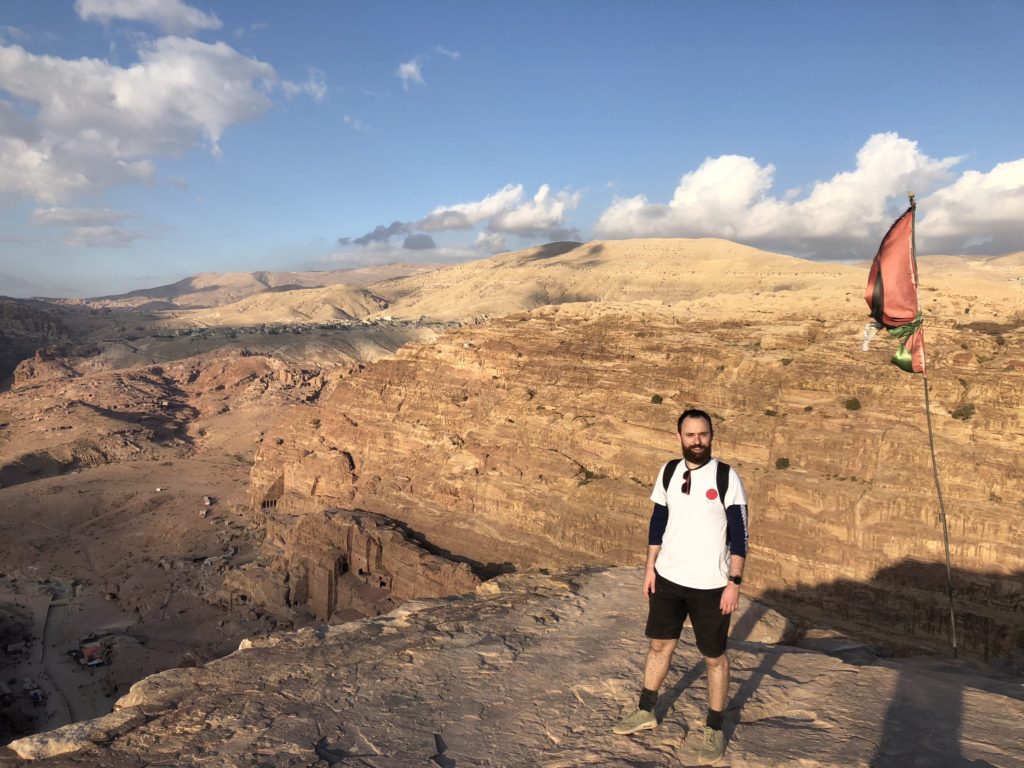 Man standing on a rugged, sandy landscape