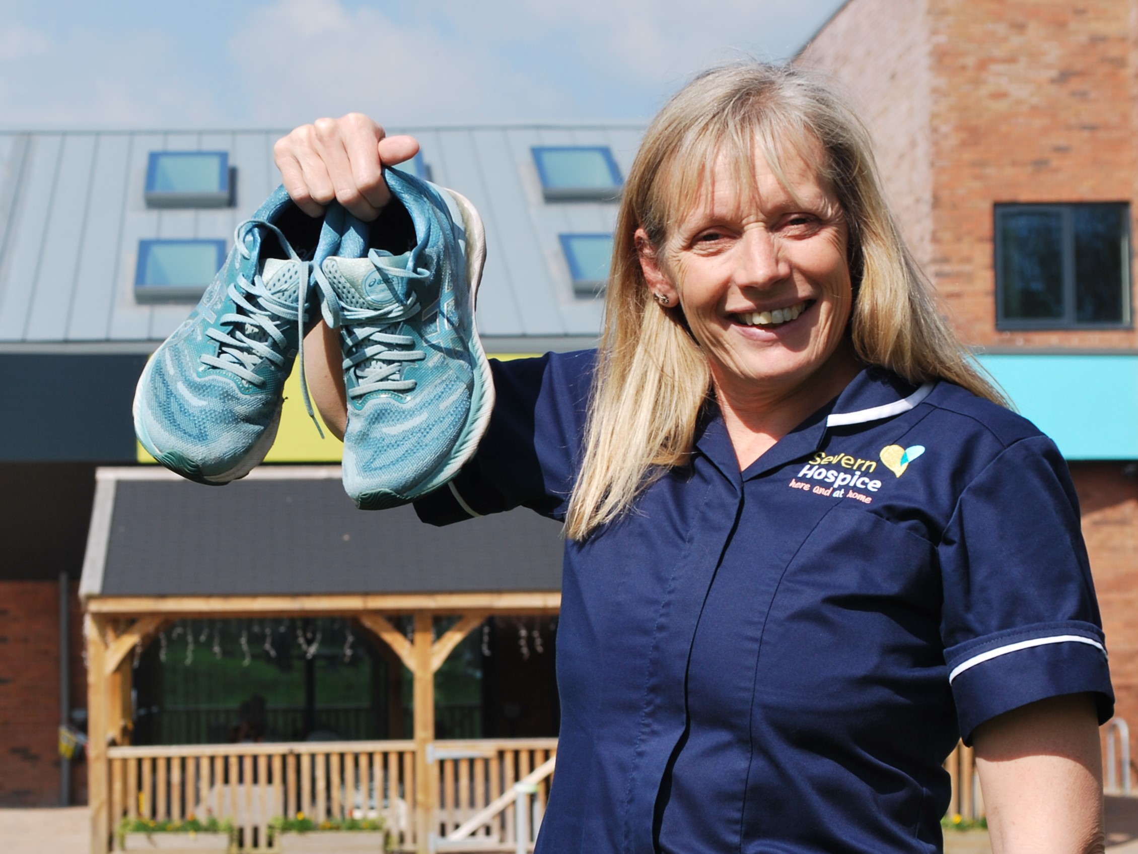 Sister holding pair of trainers