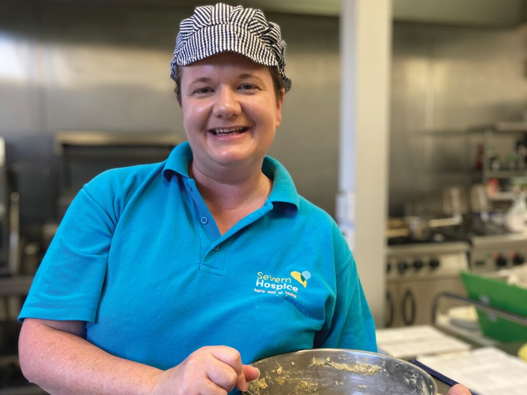 Chef holding bowl in kitchen setting