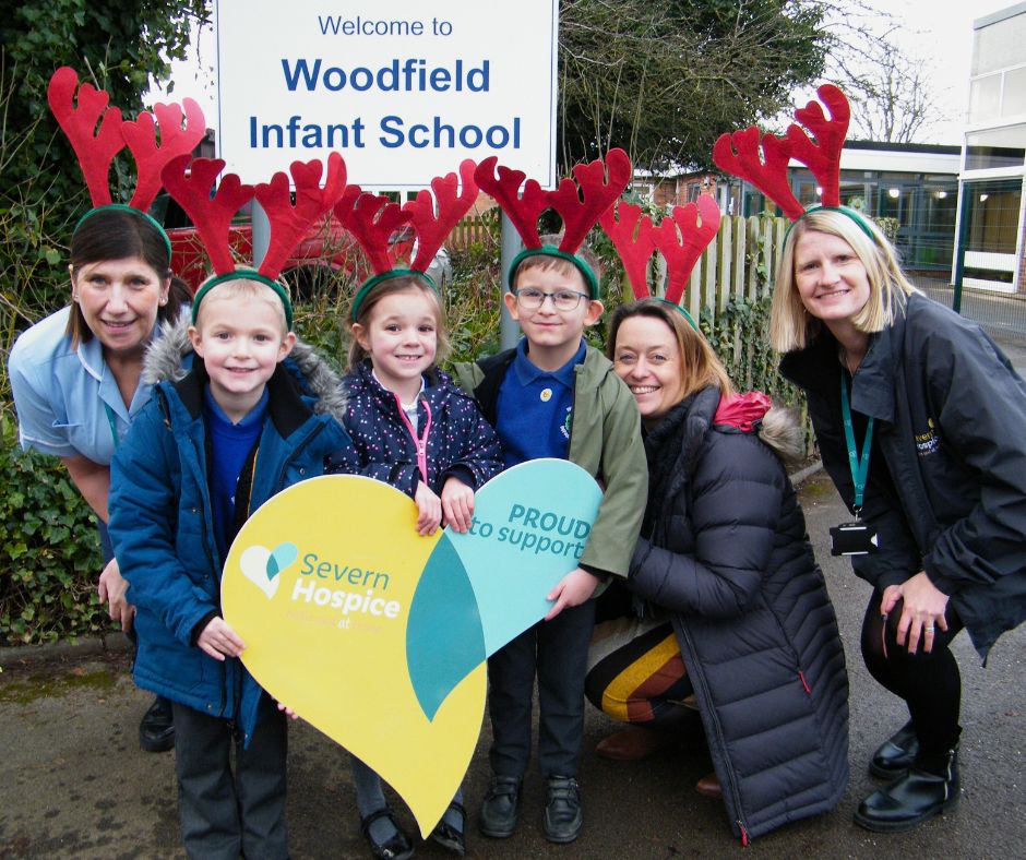 Photo of of Sharon Potter, Healthcare Assistant at Severn Hospice with pupils from Woodfield Infant School, Hughie Teeder, Fearne Kelly and Eric Waters alongside Head Teacher Beck Preece and Senior Community Fundraiser, Nicky Green. Pupils and staff at Woodfield Infant School took part in Severn Hospice's Rudolph Relay event in 2023.