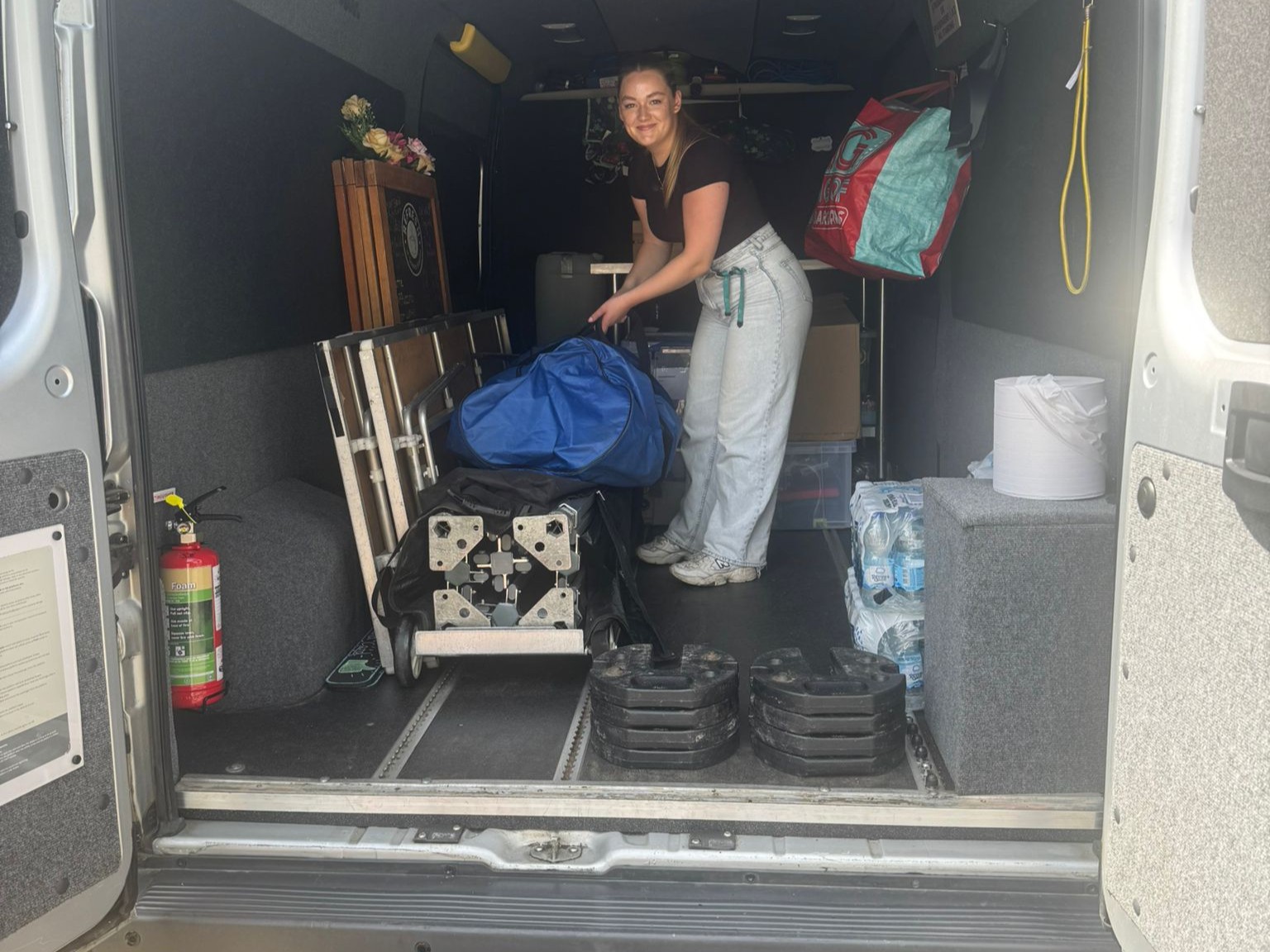 Refresh event volunteer loading a van with equipment for a pop-up cafe